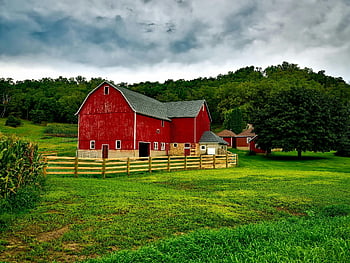 Red Barn, Wisconsin, vibrant red, lush greenery, cloudy skies, farm scene, rural landscape, countryside, wooden fence, agricultural setting