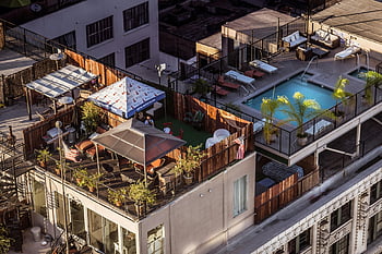aerial view, condominium, swimming pool, rooftop terrace, city setting, stylish terrace, seating area, urban living, outdoor space, modern design, poolside relaxation
