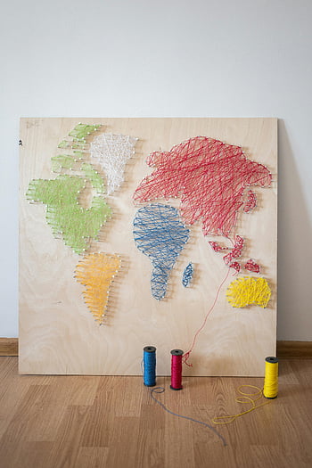 string art, world map, vibrant string art, wooden board, colorful threads, continents, creative string artwork, string art map, wooden art, colorful map, string art decoration