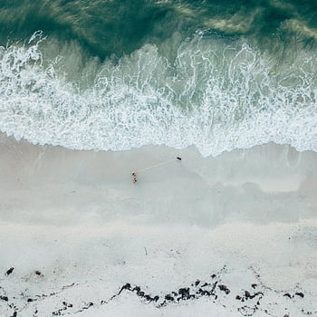 aerial view, ocean wave, sandy beach, gentle waves, peaceful seaside, aerial photo, tranquil scene, seaside escape, beach waves, ocean scenery, aerial beach view