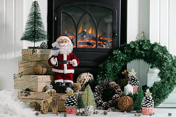 Santa Claus, fireplace, cozy room, Christmas scene, gifts, warm fireplace, Christmas decorations, pinecones, wreath, holiday setting, festive atmosphere