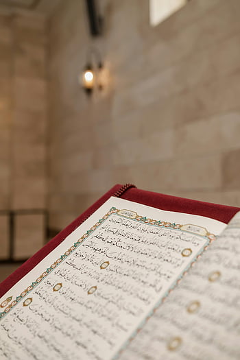 Koran, Nahaufnahme, Arabische Kalligraphie, Moscheeeinstellung, muslimische Kultur, Koran offen, kompliziertes Design, religiöser Text, islamische Kunst, heiliges Buch, Spirituelle Lesen