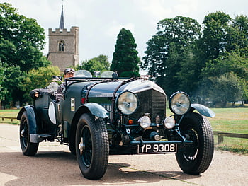 classic green vehicle, vintage car, scenic road, historic church, classic car, man driving, green car, vintage automobile, scenic drive, historic background, classic automobile