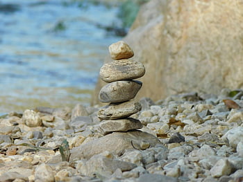 gray pile of stone, body of water, balanced stack, pebbles, flowing river, peace, tranquility, serene image, riverbank, natural balance, stone stacking