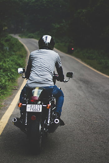 man riding motorcycle, winding forest road, clear day, motorcycle rider, forest road, man on motorcycle, outdoor ride, motorcycle adventure, scenic road, motorbike journey, helmeted rider