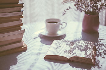 opened book, ceramic mug, serene scene, books, coffee cup, cozy ambiance, shadows, table setting, reading nook, natural light, still life