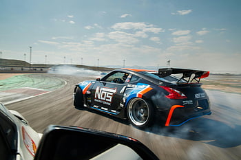 Black race car, drifting, professional circuit, high speed, thrilling action, race car, circuit track, NOS energy drink, Nexen Tire, smoke, tires