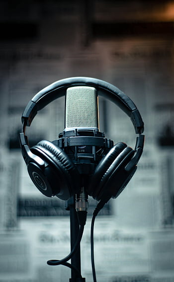 black headset, condenser microphone, studio environment, sound recording, podcasting, headphones, microphone stand, audio equipment, professional recording, studio setup, recording studio
