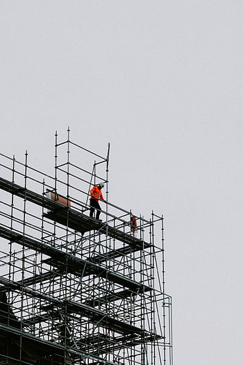 construction worker, building under construction, scaffolding, safety gear, building site, construction site, worker on scaffolding, construction industry, construction safety, high-altitude work, construction equipment
