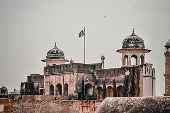 Lahore Fort, Pakistan, UNESCO World Heritage site, Mughal architecture, historic fort, Pakistani flag, ancient architecture, cultural landmark, travel destination, historical site, domed structures