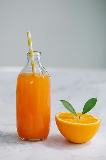orange juice, clear glass bottle, fresh orange juice, half orange, marble surface, yellow straw, citrus fruit, healthy drink, vitamin C, fruit juice, refreshing beverage