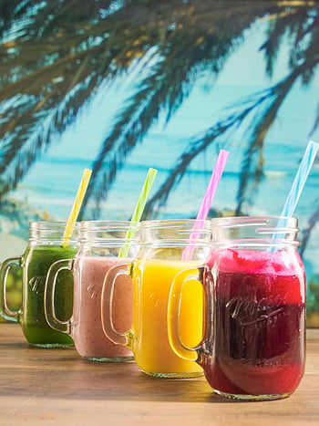 fruit juice, mason jars, colorful smoothies, tropical backdrop, health drinks, refreshment, smoothie options, fruit smoothies, mason jar drinks, tropical smoothies, healthy beverages