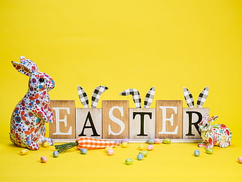 Easter decoration, yellow background, colorful Easter bunnies, Easter eggs, festive vibe, Easter letters, bright yellow, Easter carrots, Easter bunnies and eggs, Easter festive, Easter scene