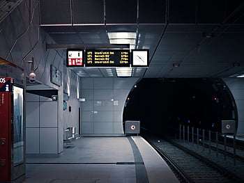 subway platform, modern subway, illuminated signs, empty platform, subway tracks, tunnel entrance, modern station, subway station, urban transportation, public transit, modern design