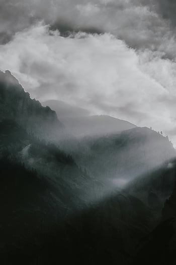 mountains, fog-covered, mountain range, dramatic lighting, clouds, panoramic view, misty mountains, natural landscape, mountain scenery, atmospheric view, mountain peaks