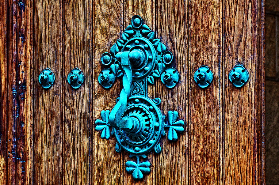 wooden door, metal knocker, antique design, blue patina, decorative hardware, rustic texture, ornate pattern, vintage style, door handle, aged wood, metal studs