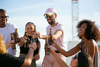 friends toasting, beer bottles, outdoor celebration, diverse group, cheering friends, social gathering, outdoor party, beer toast, group celebration, friends drinking, outdoor event