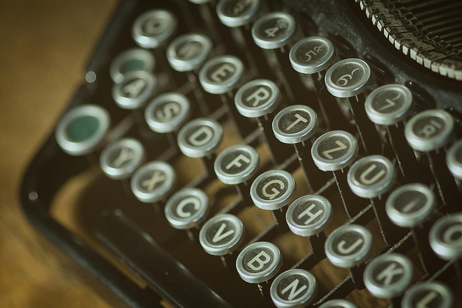 vintage typewriter, typewriter keyboard, round keys, old typing device, close-up view, black and gray keys, shallow photography, retro typewriter, antique typewriter, typewriter details, vintage keys