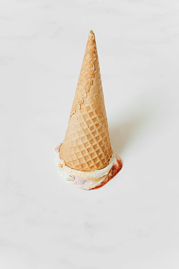 upside-down ice cream, melting ice cream, ice cream cone, white background, close-up, waffle cone, dessert, sweet treat, frozen dessert, food photography, culinary art