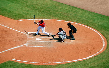 baseball game, batter swinging, catcher, umpire, baseball stadium, action shot, baseball player, two men, baseball field, sports action, baseball action