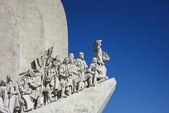 Monument of Discoveries, Lisbon, Portugal, white marble statues, explorers, roof, white and blue sky, iconic monument, historical figures, outdoor sculpture, blue sky