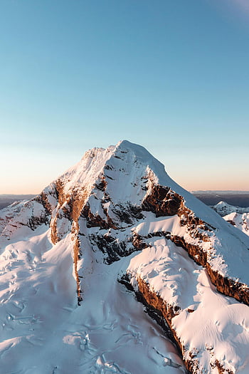 snow-covered mountain peak, clear sky, Wānaka, Otago, New Zealand, stunning view, mountain landscape, winter scenery, alpine view, natural beauty, snow-capped summit