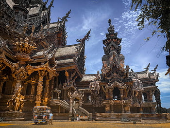 Sanctuary of Truth, Pattaya, Thailand, wooden architecture, intricate details, craftsmanship, blue sky, museum, tourist attraction, cultural landmark, travel destination