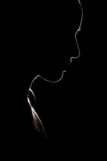 silhouette photo, woman silhouette, dark background, mystery, solitude, artistic silhouette, person silhouette, black and white, profile view, minimalistic, shadow art
