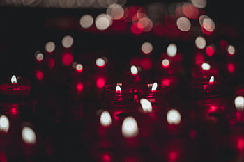 red candles, candle flames, red and white bokeh, warm ambiance, intimate atmosphere, close-up photo, candlelight, bokeh effect, romantic lighting, candle photography, red candlelight