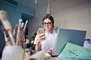 kobieta, Biała koszulka, smartfon, laptop, kreatywny obszar roboczy, przybory do sztuki, biurko, okulary, wnętrz, codzienny, technologia