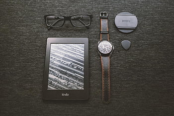 black kindle tablet, turned on, e-reader, glasses, wristwatch, black background, flat lay, tech accessories, digital device, modern gadgets, e-ink display
