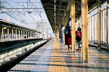 Nishinomiya train station, commuters in Japan, vibrant scene, tramway, train platform, people standing, train station, commuters, Japan, train tracks, station platform