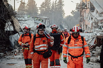 paramedics, demolished city, search and rescue, orange uniforms, demolished area, assessing damage, carrying out operations, rescue team, emergency response, disaster relief, urban rescue