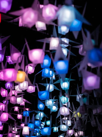 colorful lanterns, origami lanterns, illuminated lanterns, festive atmosphere, vibrant colors, night scene, assorted colors, decorative lanterns, paper lanterns, hanging lanterns, colorful lights