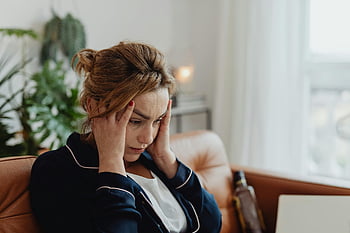 woman in pajamas, stress, frustration, mental health, hands on head, indoor setting, emotional distress, pajama-clad woman, mental well-being, home environment, personal struggles