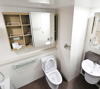 white water closet, contemporary bathroom, minimalist design, toilet, sink, storage shelves, mirror cabinet, modern bathroom, white toilet, glass shelf, white sink