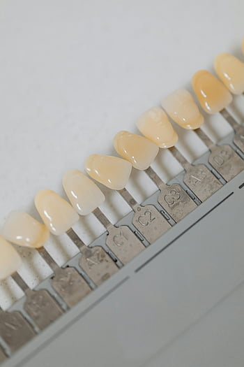 teeth implants, dental shade guide, tooth color options, dental procedures, close-up, different shades, dental implants, tooth shades, dental care, dental aesthetics, tooth whitening